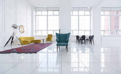 modern fashionable futuristic interior design of a spacious white hall with black and yellow furniture white tiles